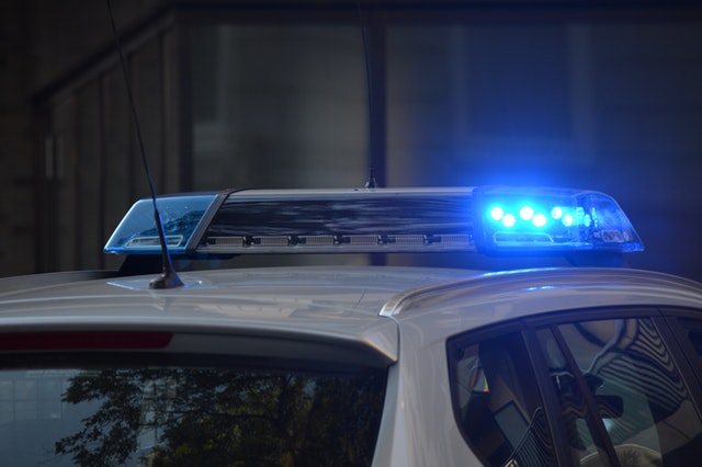 top of police car at night with a blue light